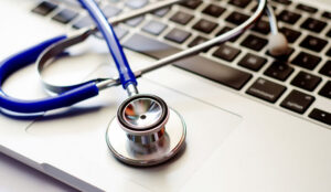 a stethoscopes onto of a laptop